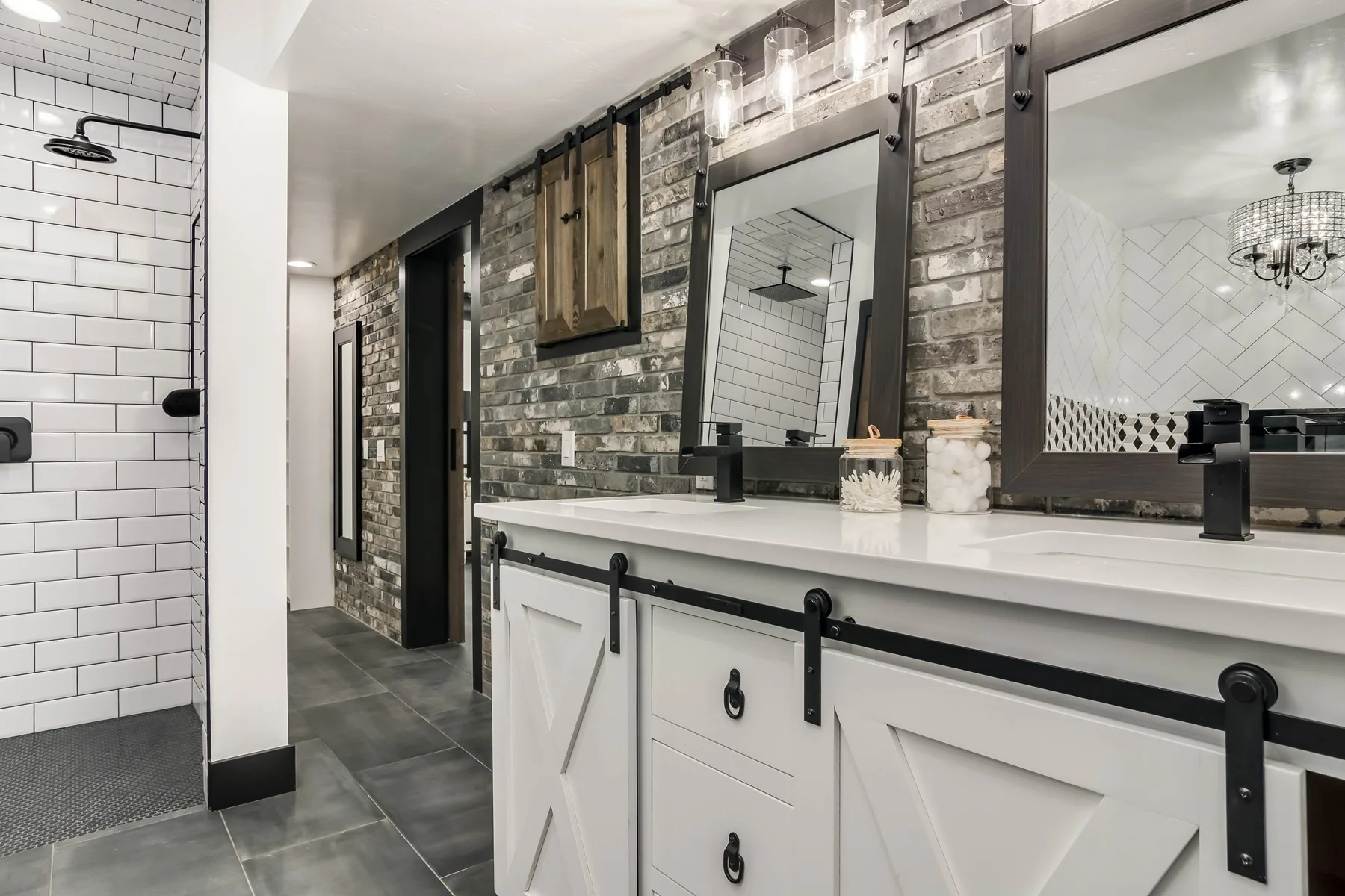 Remodelled bathroom with a stone accent wall, tiled vanity and black fixtures